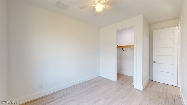 unfurnished bedroom with light wood finished floors, a closet, visible vents, a ceiling fan, and baseboards