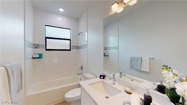 bathroom featuring toilet, washtub / shower combination, and vanity