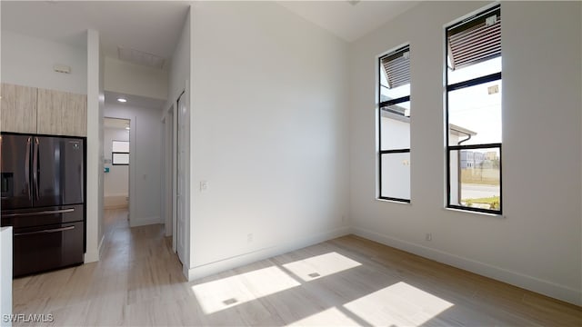 spare room with light wood finished floors and baseboards