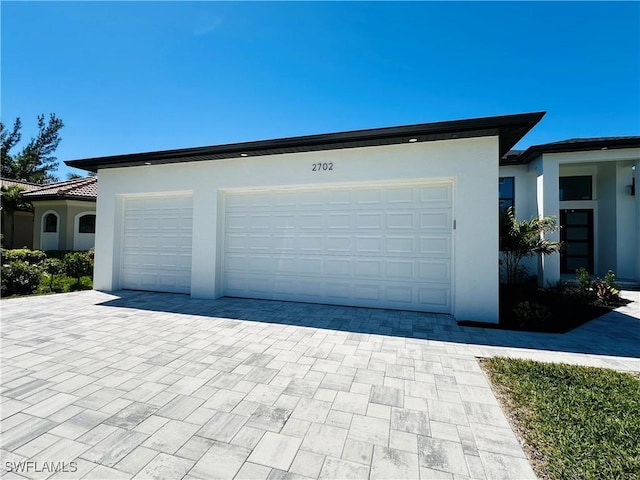 garage with decorative driveway