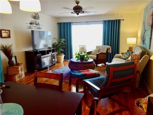 living area with ceiling fan and wood finished floors