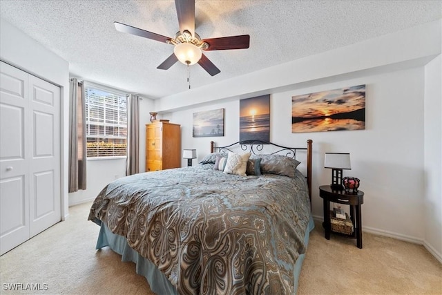 carpeted bedroom with baseboards, a textured ceiling, and a ceiling fan