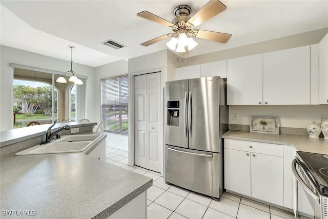 kitchen with visible vents, hanging light fixtures, appliances with stainless steel finishes, white cabinets, and a sink