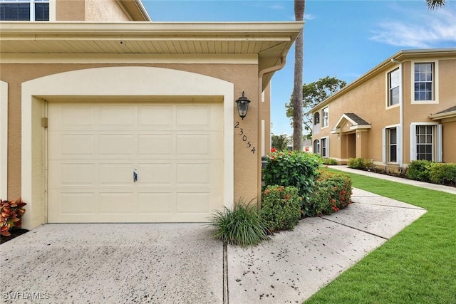 garage with concrete driveway