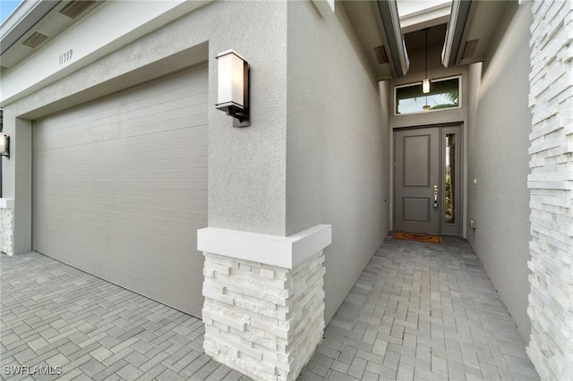 view of exterior entry featuring stucco siding