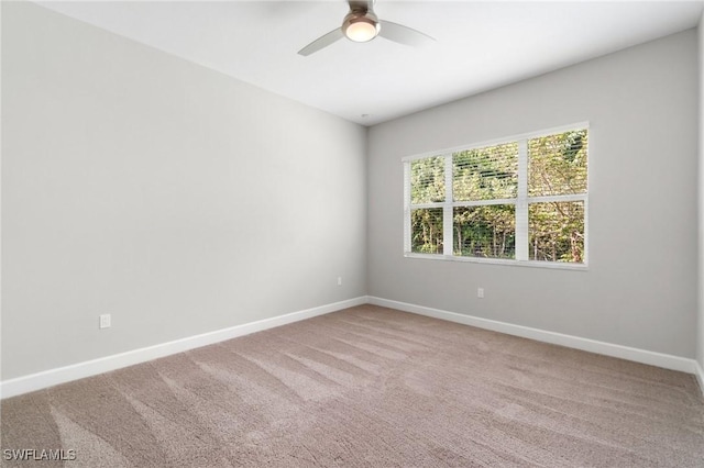 unfurnished room with ceiling fan, carpet flooring, and baseboards