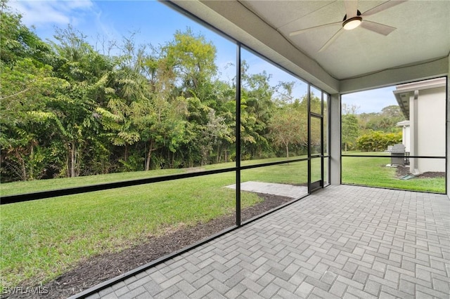 unfurnished sunroom featuring a ceiling fan