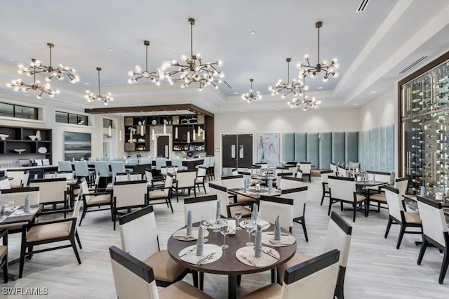 dining area featuring a high ceiling and a raised ceiling