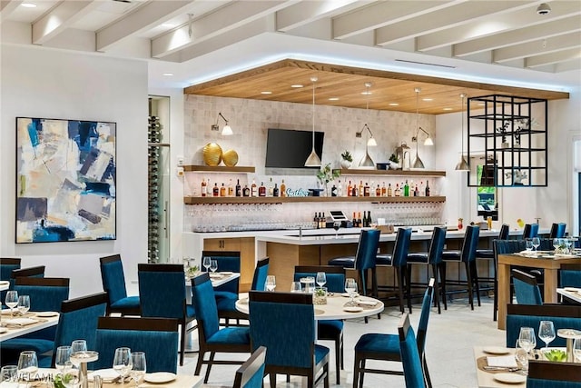 bar with tasteful backsplash, beamed ceiling, and a dry bar