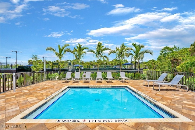 pool featuring a patio area and fence