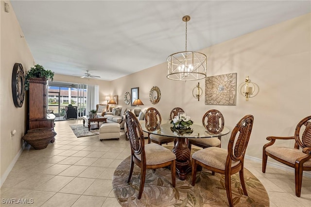 dining space featuring light tile patterned floors, ceiling fan with notable chandelier, and baseboards