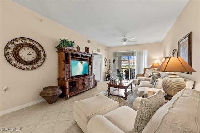 living area featuring light tile patterned flooring, visible vents, baseboards, and ceiling fan