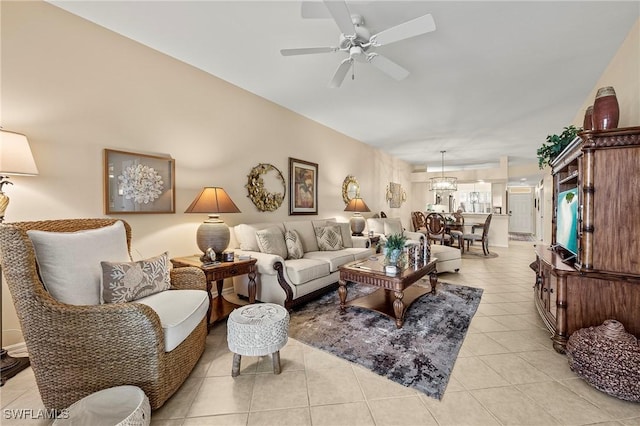 living area with light tile patterned flooring and a ceiling fan