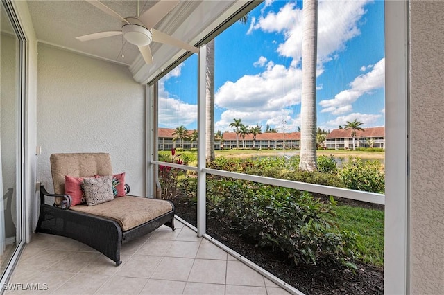 sunroom featuring a ceiling fan