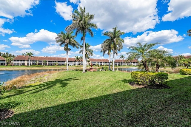 view of community featuring a lawn and a water view