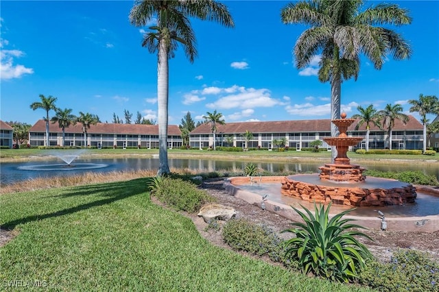 surrounding community featuring a lawn and a water view