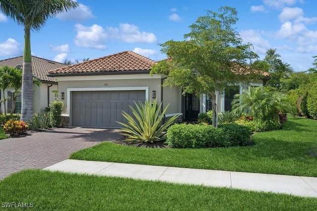 3171 Quilcene Ln, Naples, FL 34114 - view of front facade with an attached garage, stucco siding, driveway, and a tile roof