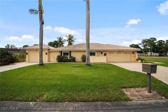 single story home featuring stucco siding, driveway, a front yard, and an attached garage