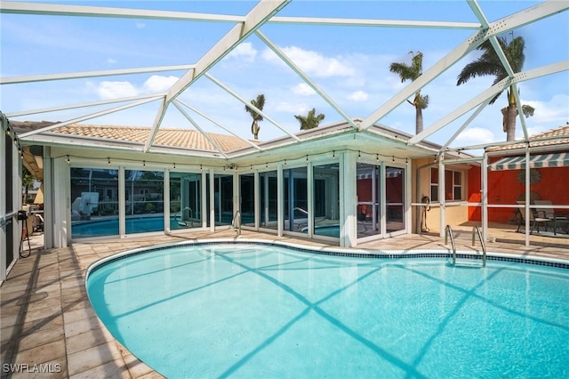 outdoor pool with a patio and a lanai