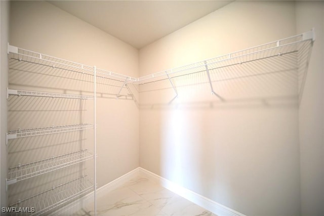 spacious closet with marble finish floor