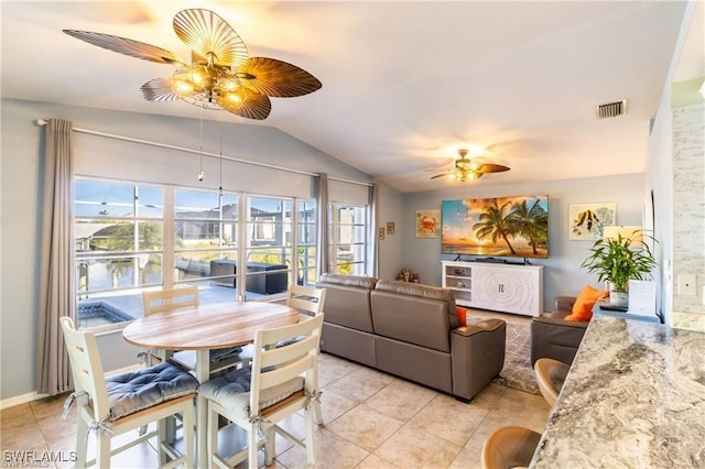 dining space featuring light tile patterned floors, visible vents, vaulted ceiling, and a ceiling fan