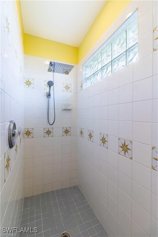 full bath with a tile shower