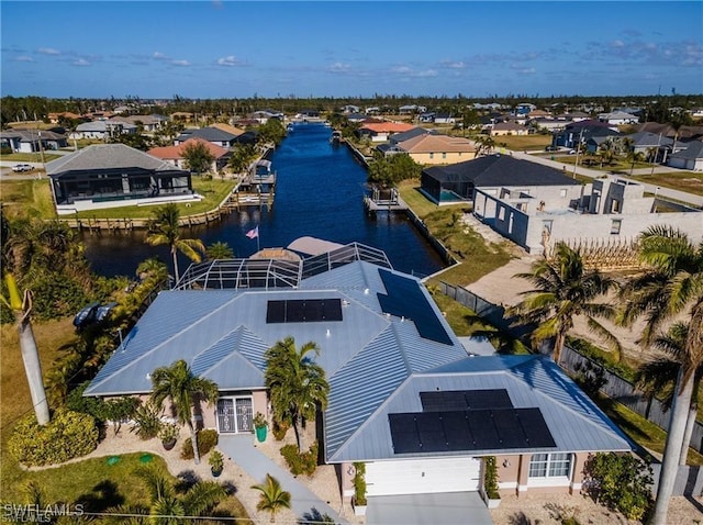 drone / aerial view featuring a water view and a residential view