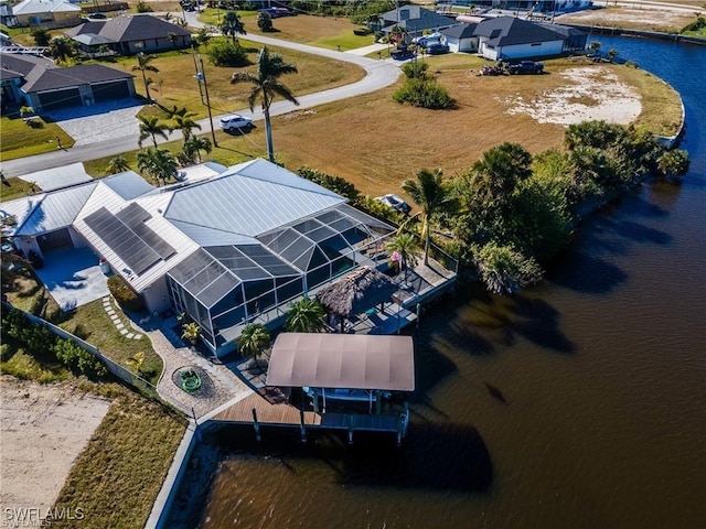 drone / aerial view with a water view and a residential view