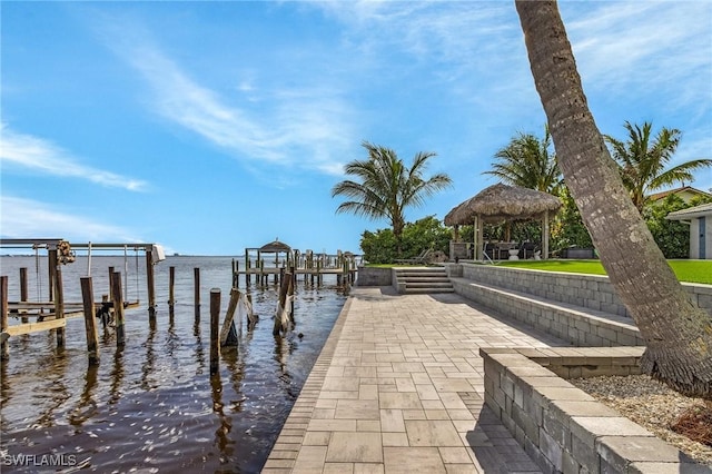 view of dock featuring a water view, boat lift, and a gazebo