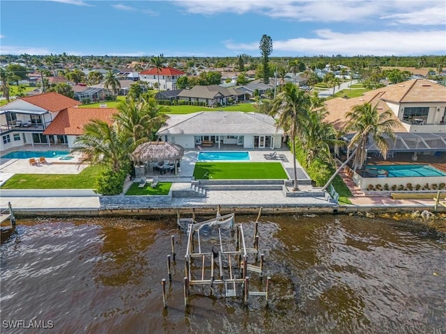 drone / aerial view featuring a residential view and a water view