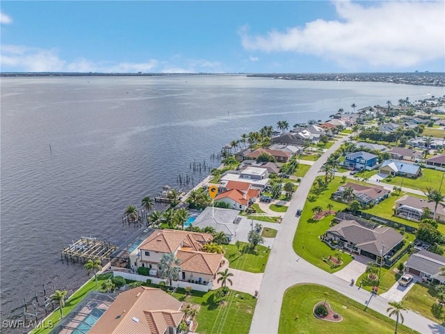 birds eye view of property with a water view and a residential view