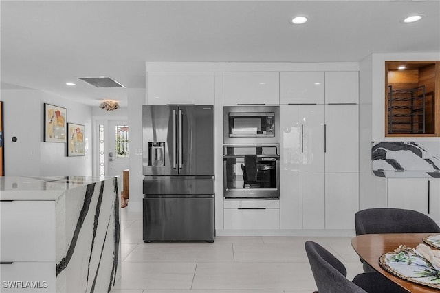 kitchen featuring white cabinets, modern cabinets, and stainless steel appliances