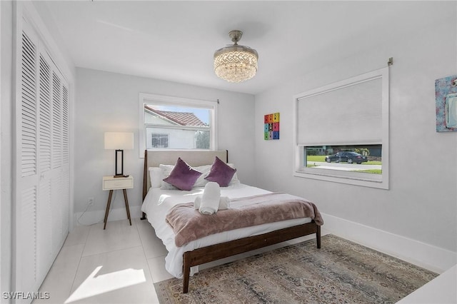 bedroom featuring tile patterned flooring and baseboards