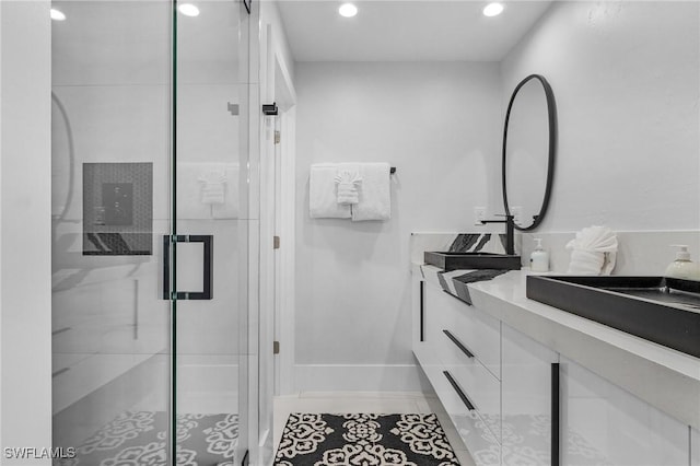 bathroom with recessed lighting, a stall shower, vanity, baseboards, and tile patterned floors