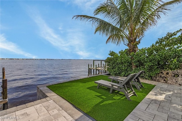 view of dock featuring a water view and a lawn