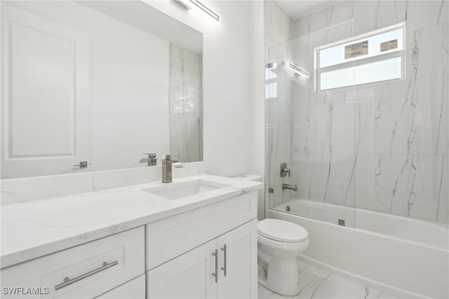 full bath with marble finish floor, shower / bathing tub combination, vanity, and toilet