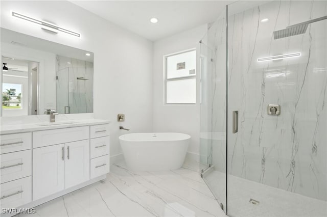 full bath featuring marble finish floor, a soaking tub, vanity, and a marble finish shower