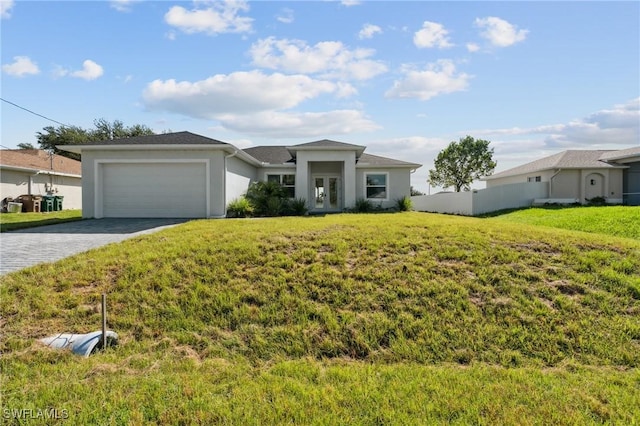 prairie-style home with a garage, fence, decorative driveway, french doors, and a front yard