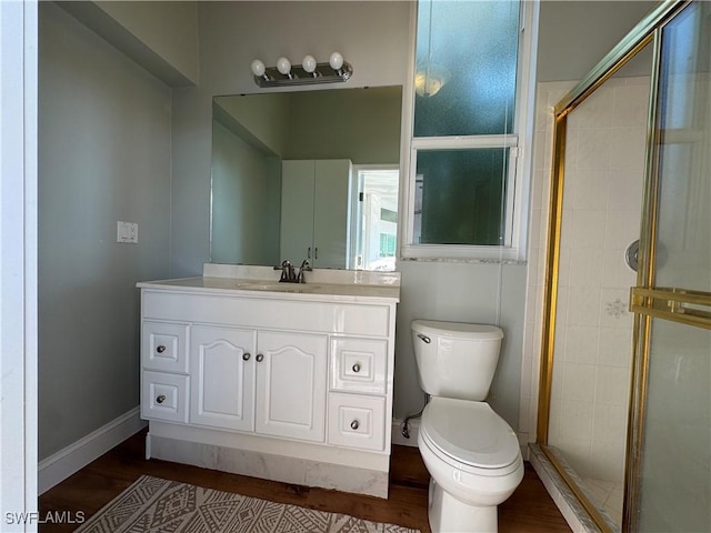 full bath featuring toilet, a stall shower, wood finished floors, and baseboards