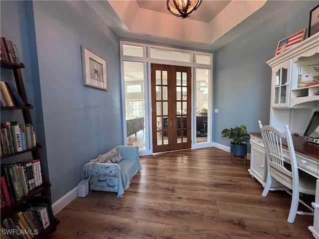 office area with french doors, dark wood-style flooring, baseboards, and a raised ceiling