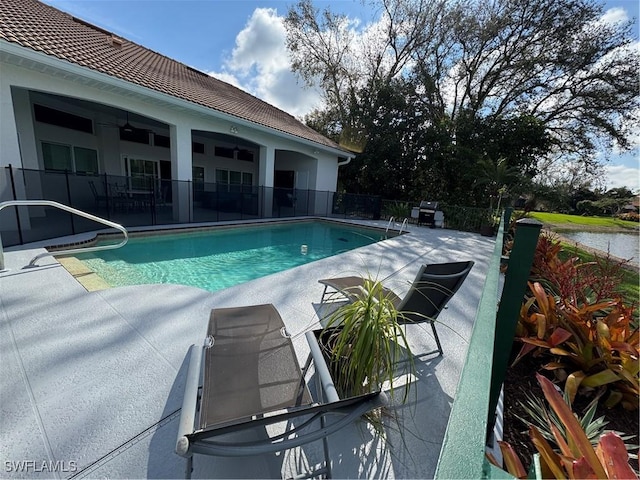 view of swimming pool with a patio area, fence, a ceiling fan, and a fenced in pool