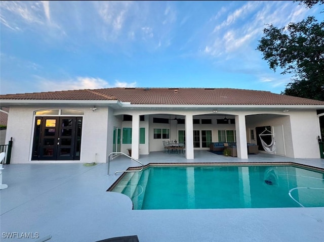 pool with outdoor lounge area, french doors, a patio area, and ceiling fan