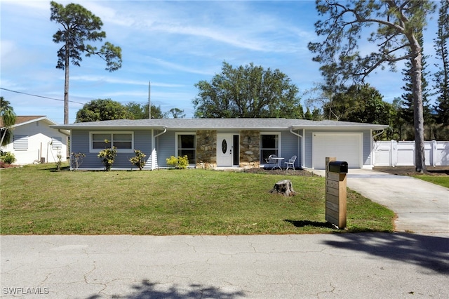 ranch-style home with fence, concrete driveway, a front yard, a garage, and stone siding