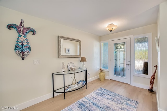 entrance foyer with wood finished floors and baseboards