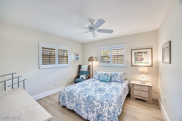 bedroom featuring a ceiling fan, baseboards, and light wood-type flooring