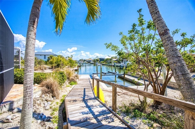 dock area featuring glass enclosure and a water view