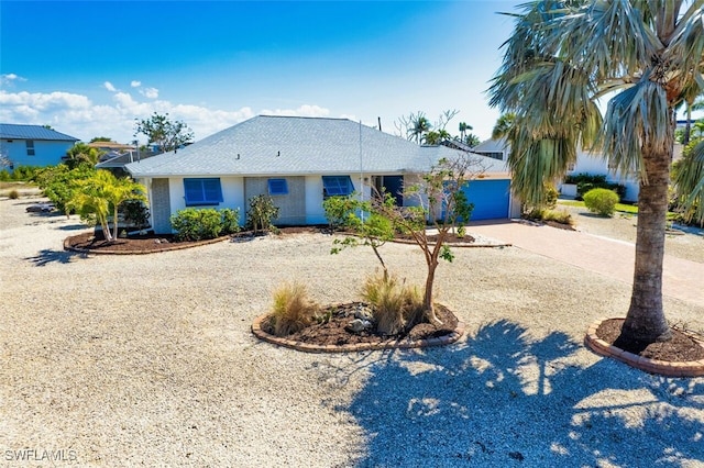 single story home featuring concrete driveway and an attached garage