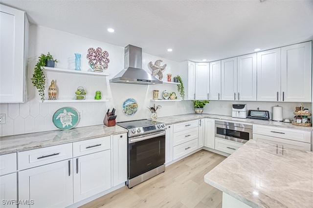 kitchen featuring stainless steel range with electric stovetop, open shelves, wall chimney exhaust hood, built in microwave, and light stone countertops