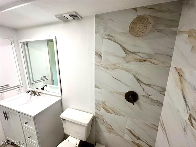 bathroom with visible vents, toilet, vanity, and a marble finish shower