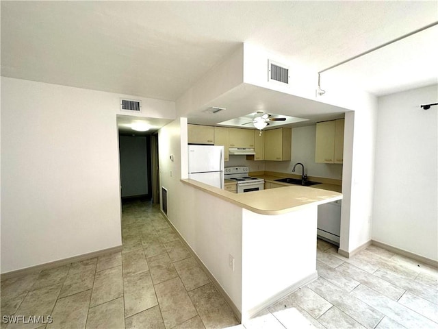 kitchen featuring light countertops, white appliances, a sink, and visible vents